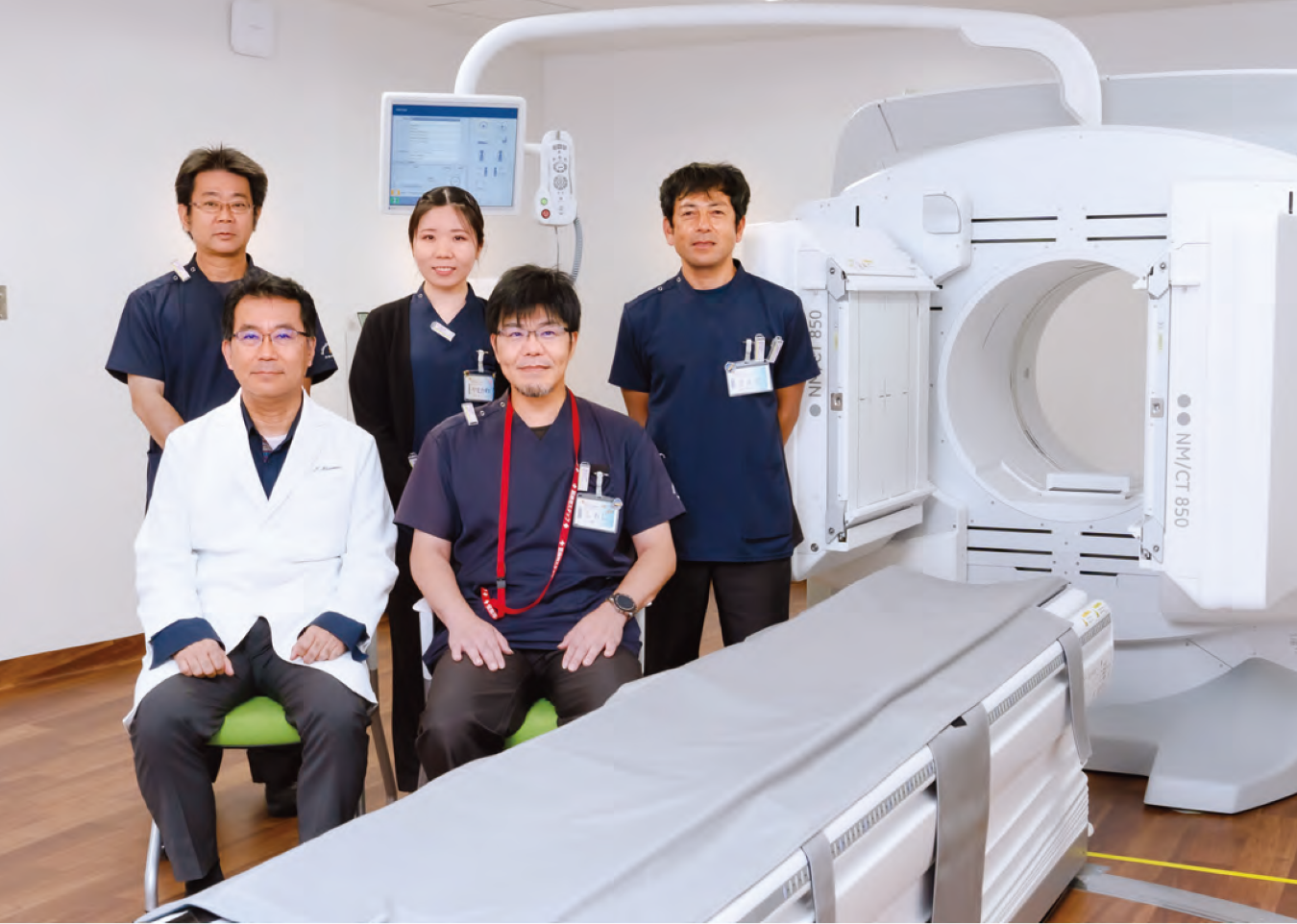 核医学検査・治療機器とチームメンバー